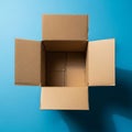 Box with flaps open on a blue background. The box is made of corrugate Royalty Free Stock Photo
