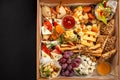 A box of food, cheese, breads, fish, shrimp. Food delivery for the company, romantic, office dinner at home. Beautiful composition