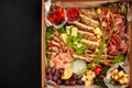 A box of food, cheese, breads, fish, shrimp. Food delivery for the company, romantic, office dinner at home. Beautiful composition Royalty Free Stock Photo