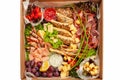 A box of food, cheese, breads, fish, shrimp. Food delivery for the company, romantic, office dinner at home. Beautiful composition