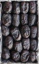box of fresh organic mazafati dates for food background. dried dates on carton paper box . on white background. top view