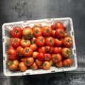 A box of fresh tomatoes harvested from his garden Royalty Free Stock Photo