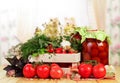 Box fresh tomatoes and jars pickled spices isolated on white.