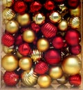 Box full of red and gold Christmas tree ornaments Royalty Free Stock Photo