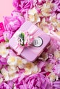Box with gift  around roses  and  jasmine background. romantic and beauty concept. top view Royalty Free Stock Photo