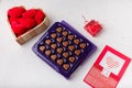 Box of heart shaped chocolates, postcard, red candle, wooden box of fabric hearts on white. Valentines day 14 February present Royalty Free Stock Photo