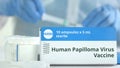 Box with human papilloma virus HPV vaccine on the table against blurred lab assistant or doctor. Fictional phaceutical Royalty Free Stock Photo