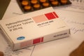 A box of hyroxychloroquine tablets on a prescription paper