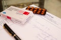 A box of hyroxychloroquine tablets on a prescription paper