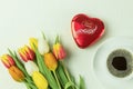 A box of Lindt Lindor chocolates in a red box in the shape of a heart and fresh flowers Royalty Free Stock Photo