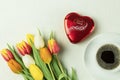 A box of Lindt Lindor chocolates in a red box in the shape of a heart and fresh flowers Royalty Free Stock Photo