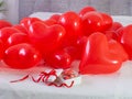 Box with macaron cookies and red baloons on the bed Royalty Free Stock Photo