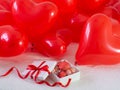 Box with macaron cookies and red baloons on the bed Royalty Free Stock Photo