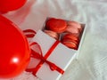 Box with macaron cookies and red baloons on the bed Royalty Free Stock Photo