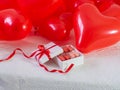 Box with macaron cookies and red baloons on the bed Royalty Free Stock Photo