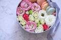 Round Box with flowers and almond cookies on marble background