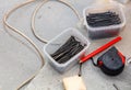 A box of nails and a box of screws are on a table Royalty Free Stock Photo