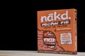 box of nakd fruits and nuts bars on a dark black background. Isolated. Peacan pie.