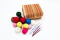 A box for needlework, colorful reels of thread and a set of hooks for home knitting. Still life on a white background Royalty Free Stock Photo