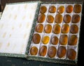 Box of ochre yellow f rune stones with symbols.