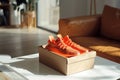 box with a pair of orange sneakers on a white table