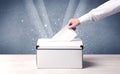 Box with person casting vote on sparkling background Royalty Free Stock Photo