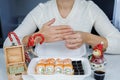 A box of Philadelphia rolls on the table in the kitchen. Fast delivery sushi in a white container Royalty Free Stock Photo