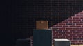 Box placed on a pedestal in front of a brick wall illuminated by diagonal sunlight Royalty Free Stock Photo