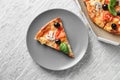Box and plate with tasty Italian pizza on table Royalty Free Stock Photo