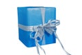 A box sealed with a beautiful blue sky-blue paper and tied with a white ribbon and a small silver bow on top of an Royalty Free Stock Photo