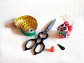 Scissors, pincushion, needles, thimble, centimeter