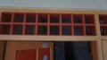 Box shaped air vents above the orange door. Decoration photo