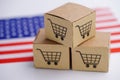 Box with shopping cart logo and United State of America USA flag : Import Export Shopping online or eCommerce Royalty Free Stock Photo