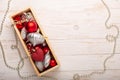 Box with silver red christmas gifts on white wooden background Royalty Free Stock Photo