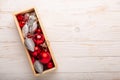 Box with silver red christmas gifts on white wooden background Royalty Free Stock Photo
