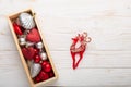 Box with silver red christmas gifts on white wooden background Royalty Free Stock Photo