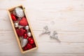 Box with silver red christmas gifts on white wooden background Royalty Free Stock Photo