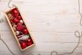 Box with silver red christmas gifts on white wooden background Royalty Free Stock Photo