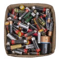 Box of small domestic dry cell batteries, old trash to recycle. Isolated on white. Alkaline. Europe, UK AA and AAA size.