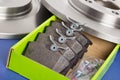 Box of spare pads with car brake discs
