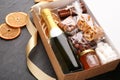 Box with stylish craft gift set on black slate table, closeup