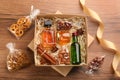 Box with stylish craft gift set on wooden table, flat lay