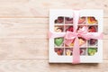 Box with sweet chocolate candies on color background, Various candy sweets. Valentines day gift box. Top view flat lay Royalty Free Stock Photo