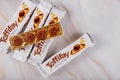 Box of Toffifee candies with pieces of caramel candy with matble table