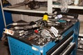 Box with tools and spare parts lying on it in disarray in the process of repairing the car in the workshop for vehicle