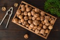 a box of walnuts and a nut cracker on a table Royalty Free Stock Photo