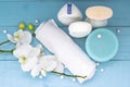 Box of washing, white towel and orchid on blue wooden background Royalty Free Stock Photo