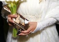 Box with wedding rings and white bouquet in hands of bride Royalty Free Stock Photo