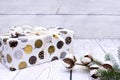 box and wrapping paper white with painted Christmas balls, cotton branches, spruce branch, on wooden background Royalty Free Stock Photo