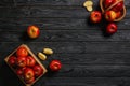 Box and wicker basket with ripe tasty apples on dark wooden background Royalty Free Stock Photo